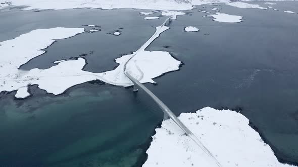 Drone footage of a car crossing a bridge in the Lofoten Islands, Norway.