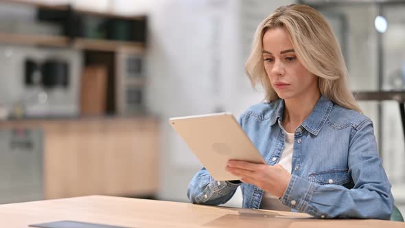 Online Video Chat on Tablet By Young Woman at Work