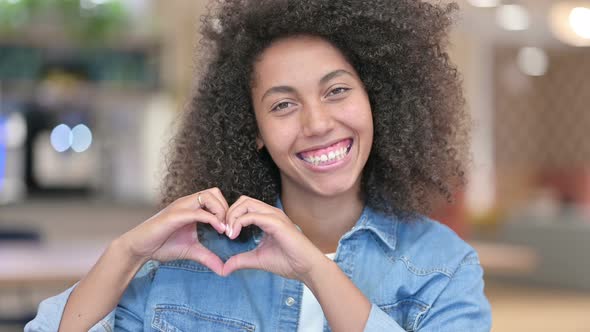 African Woman Showing Heart Sign with Hand