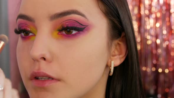 Professional Makeup Artist Makes Bright Fashion Makeup to Model in Yellow and Pink Eyeshadows on the