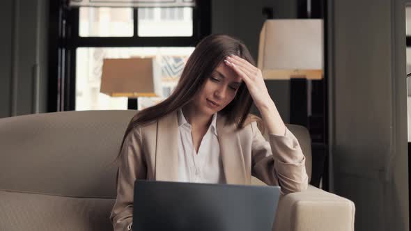 Tired Depressed Businesswoman Working on Laptop Thinking About Problem in Hotel