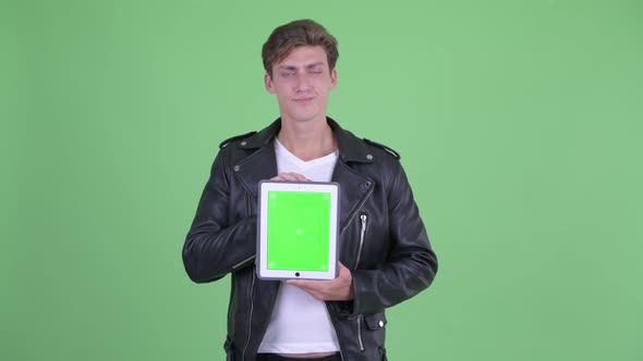 Stressed Young Rebellious Man Showing Digital Tablet