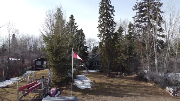 Dolly Back from Canada Flag in front of Cottage