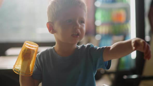 Toddler Boy with Glasses Put on Hand Talks in Restaurant