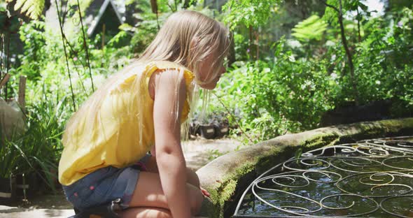 Little girl next to a fountain in a nature