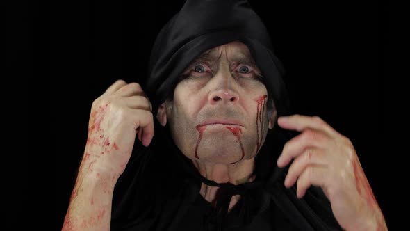 Old Executioner Halloween Makeup and Costume. Elderly Man with Blood on His Face