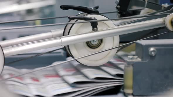 Freshly Printed Newspaper Copies After Automatic Folding in the Printing House.