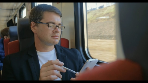 Man With Cell Phone Enjoying View From The Train alt