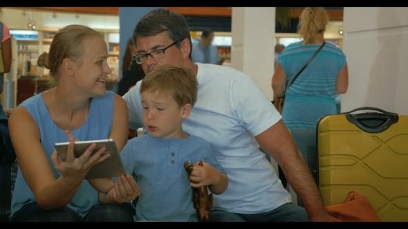 Parents And Child Using Digital Tablet alt