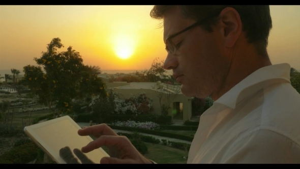 Work On Business With Pad Outdoor At Sunset