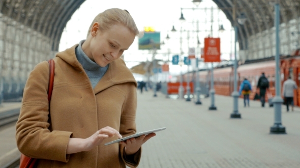 Woman With Tablet On The Railway Station alt