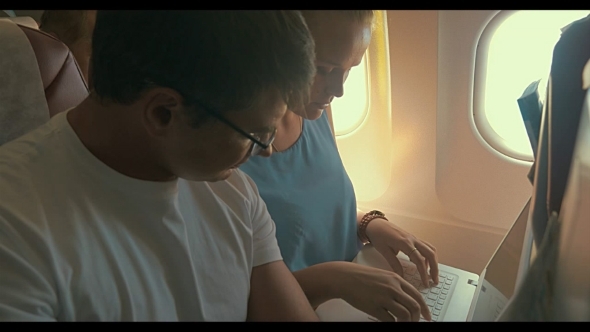 Young People Working With Laptop In Plane alt