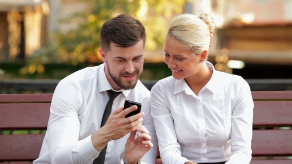 Two Business Colleagues Outdoors On a Bench alt