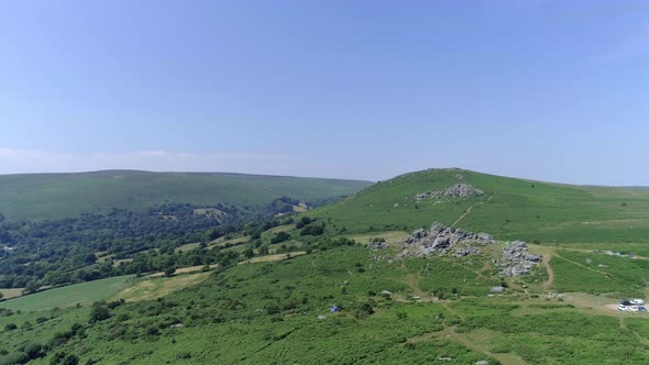 Bonehill Rocks, Wide shot aerial tracking forward over the wide expanse of Dartmoor, tors, grassy mo