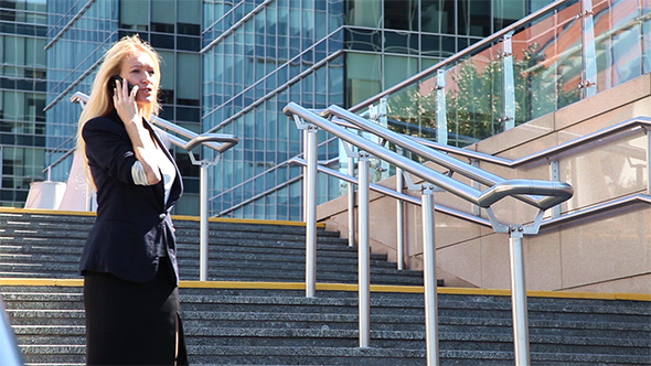 Business Woman Standing on The Stairs And Talking  alt