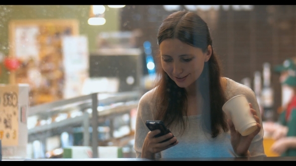 Woman With Smartphone In Coffee Shop alt
