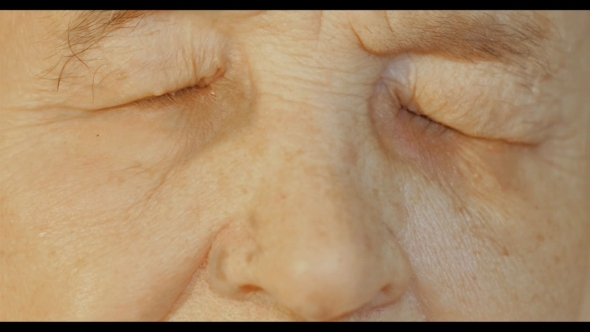 Elderly Womans Face With Tired Expression alt
