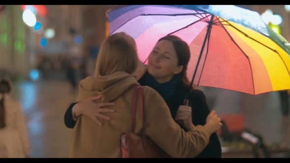 Two Women Friends Meeting In Rainy Evening alt