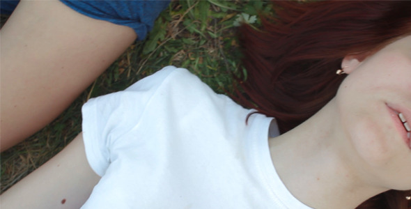 A Girl and a Boy lying on the Grass