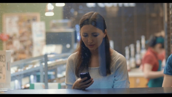 Young Woman Writing Messages In Smartphone alt