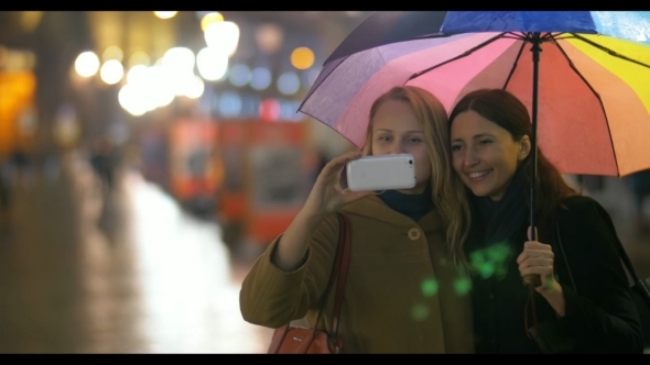 Female Friends Making Selfie Under Rainbow alt