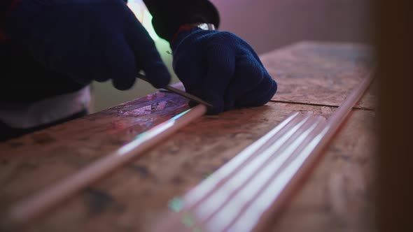 Male Hands in Gloves Preparing Neon Lightbulbs for Making Neon Close Up Shot Slow Motion