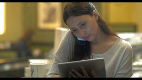 Evening With Phone And Tablet PC In Cafe alt