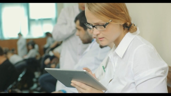 Taking Notes On Pad During Medical Conference alt