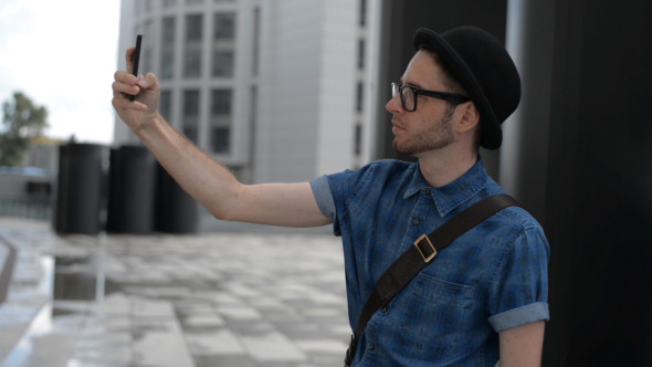 Man Takes and Send Photo with Smartphone alt