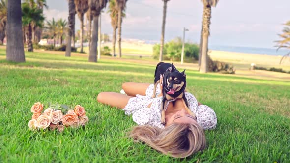 Small Dog Named Artur with Owner Relaxing on the Grass