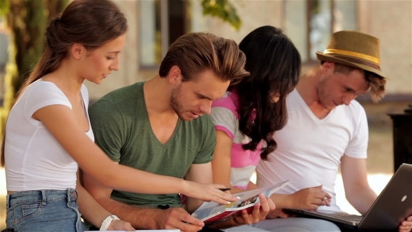 Group Of Students Studying Outdoors alt