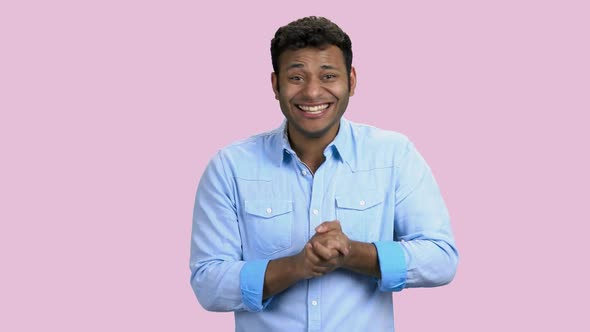 Expressive Dark-skinned Man Is Laughing on Pink Background.