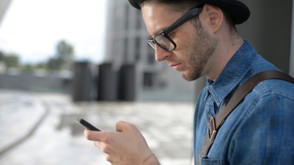 Young Man Using Smartphone alt