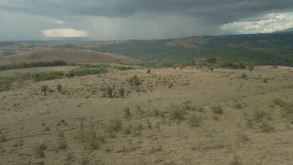 aerial drone shot of a vast expanse of grassland in the dry season with cloudy skies