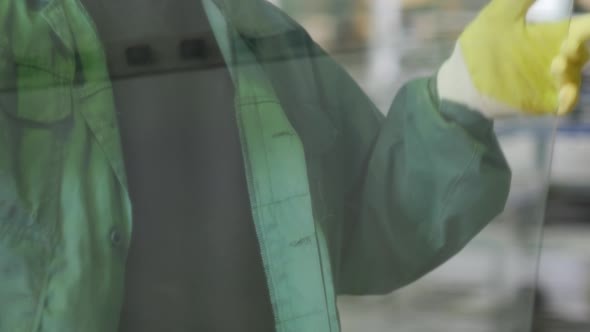 Worker in Yellow Gloves Took The Sheet of Glass