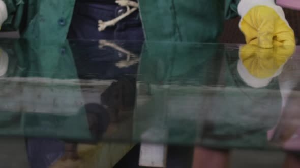 Worker in Yellow Gloves is Putting The Sheet of