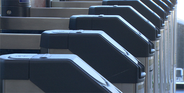 Putting ticket into barrier at train station