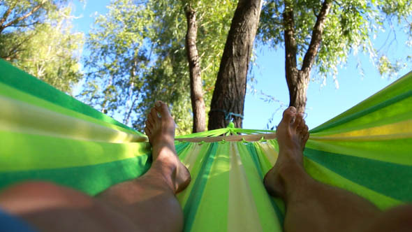 Man Rests in a Hammock