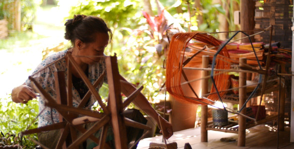 Woman Spinning Silk In Luang Prabang 