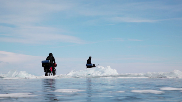 People Travel on Frozen Lake Baikal alt