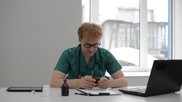 Doctor Texting Message on Smartphone