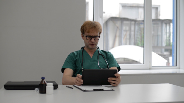 Doctor Reading on Tablet