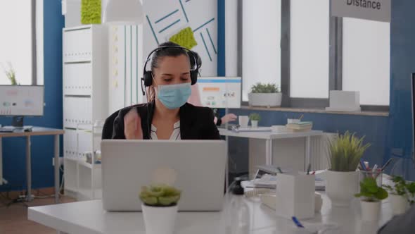 Executive Manager Wearing Protective Face Mask and Headphone
