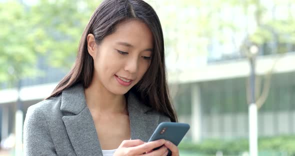 Woman use of smart phone in city