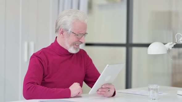 Video Call on Tablet By Old Man at Work