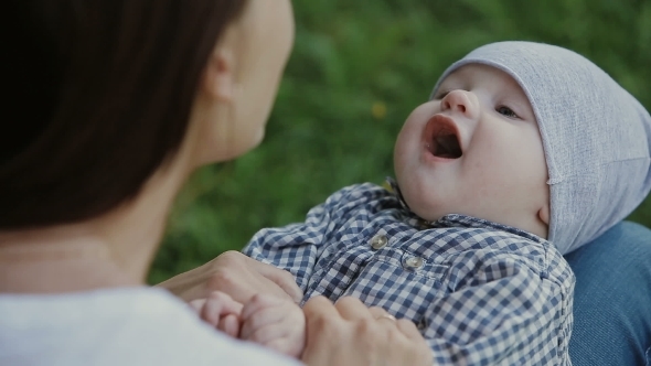 Happy Baby Boy Playing With Mother In The Park