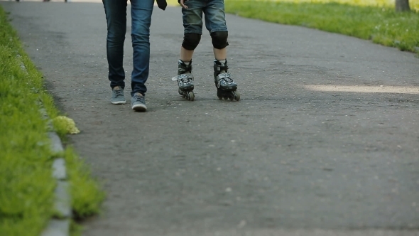 a Little Boy Learning To Roller Skate