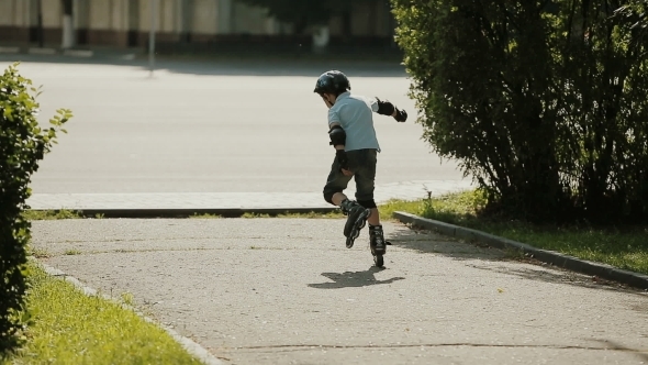 Little Boy Learning To Roller Skate