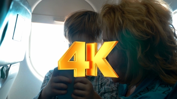 Grandmother And Grandson With Cell In The Plane