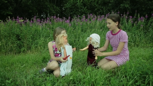 Girls Play With Dolls On Grass